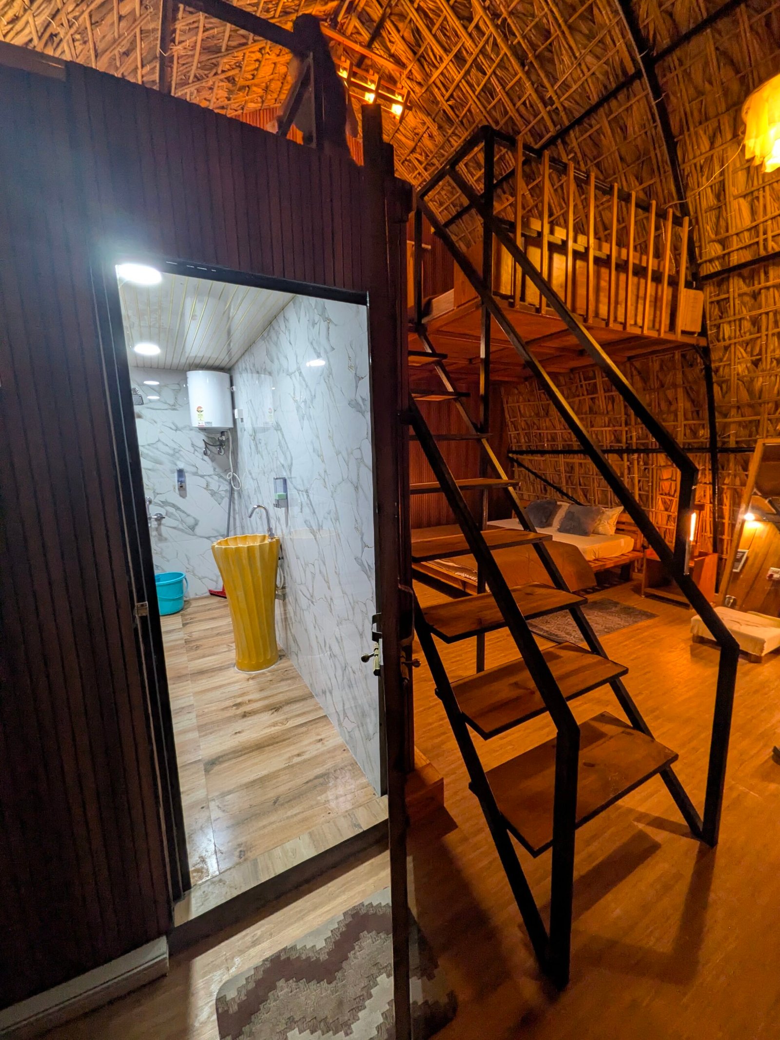 View of the room with the en-suite bathroom door open, staircase alongside